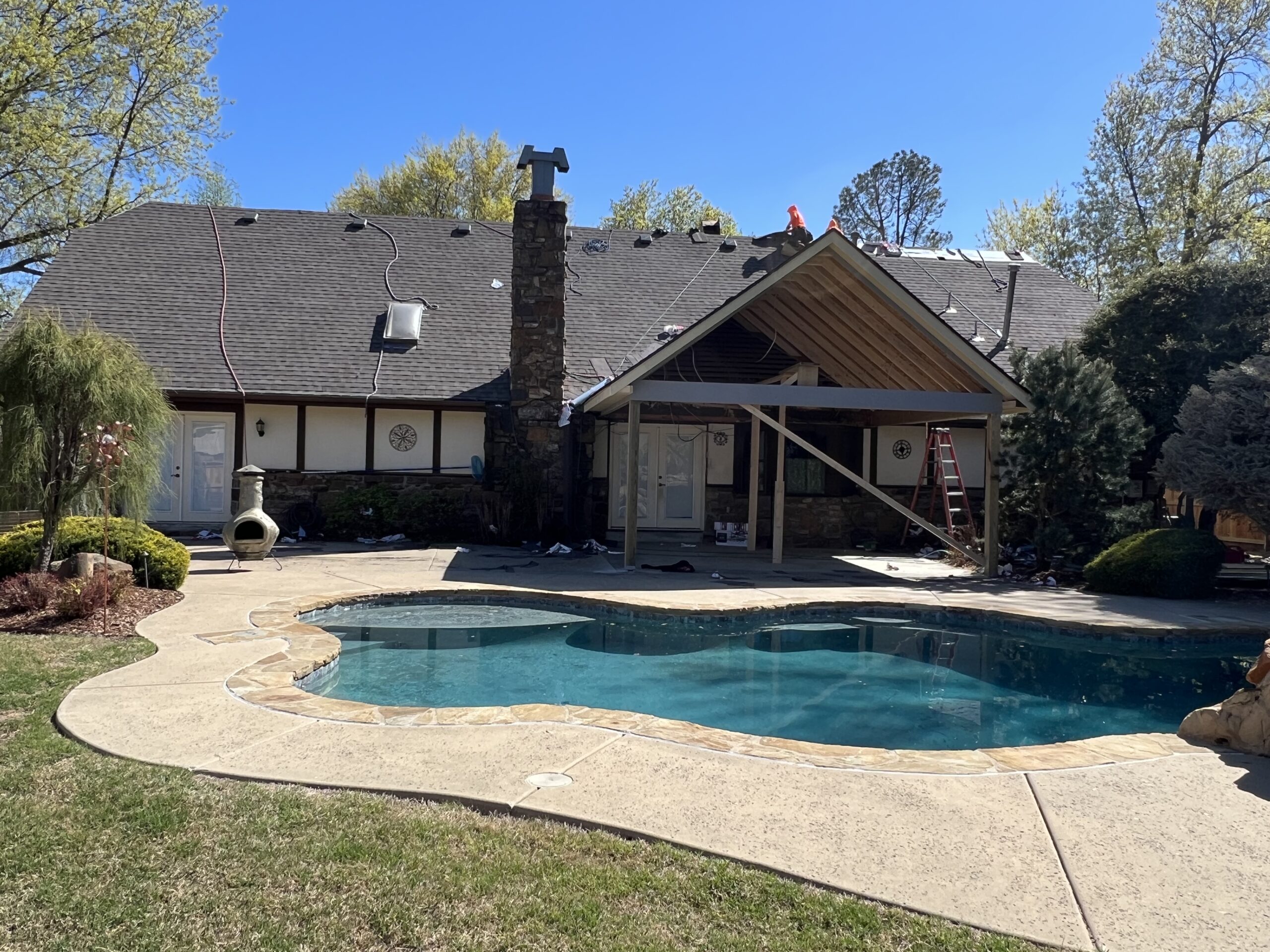 home with a backyard pool having the roof replaced